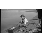 112063PD: Cleaning his catch, 1926?
