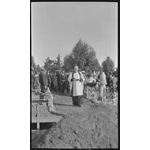 112230PD: Priest leads coffin to gravesite, 1919