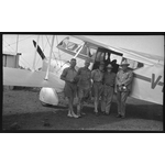 217207PD: Pilot Jimmy Woods, geologist Dr. Woolnough, and others, in front of VH-URF De Havilland DH.84 Dragon II of MacRobertson Miller Aviation Co, 1936