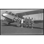 217209PD: Passengers in front of a De Havilland DH.84 Dragon II of MacRobertson Miller Aviation Co, 1936