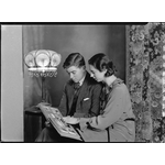095990PD: Ella and Faulkner Mackay looking at photograph album