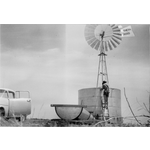 195177PD: Erecting a new windmill and water tank on Rock Hill farm, Wongan Hills, home of John P. Taggart and family, ca. 1960