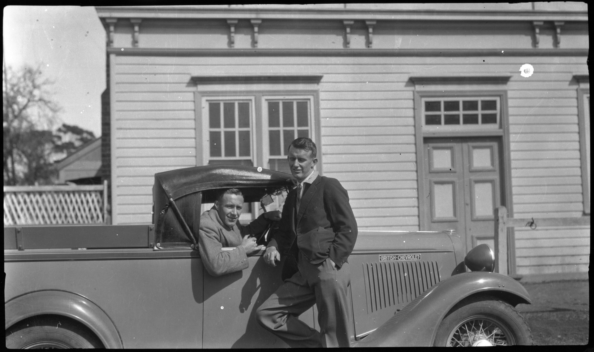 Edgar Daw Jnr leaning against Chevrolet car parked outside the Daw