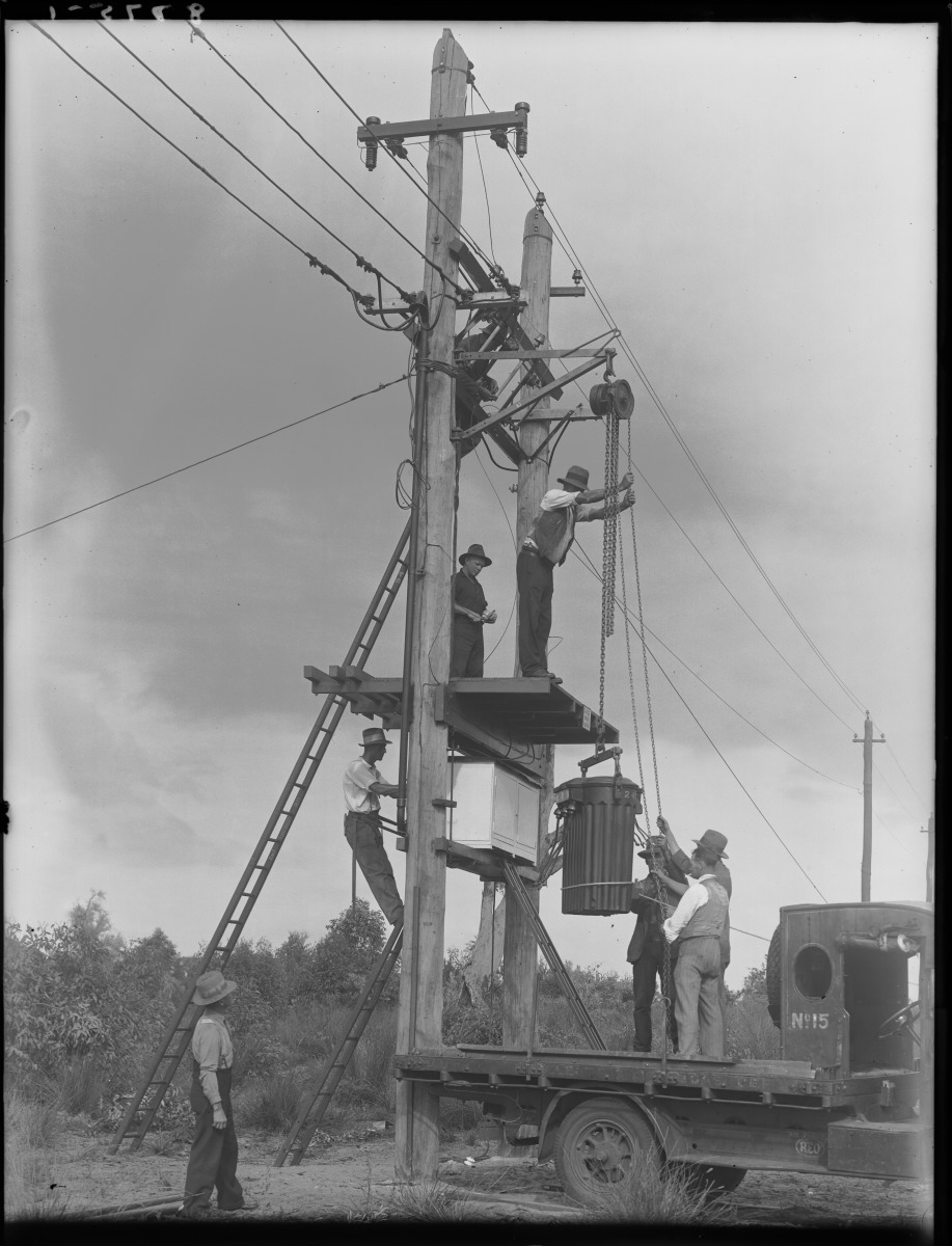 Power Utility Using Ropes Electricity equipment being installed on power pole - JPG 212.0 KB