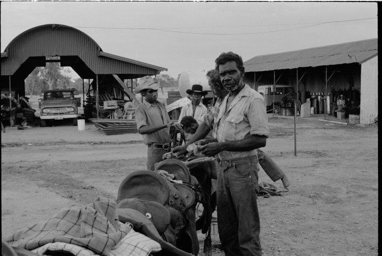 Preparing saddles for mustering on Fossil Downs Station, March 1974