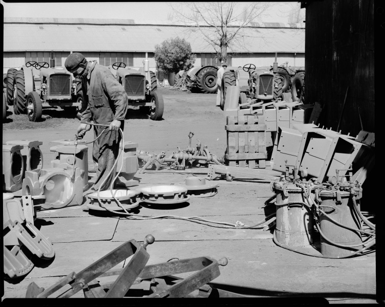 Spray painting a Chamberlain Countryman tractor and tractor parts