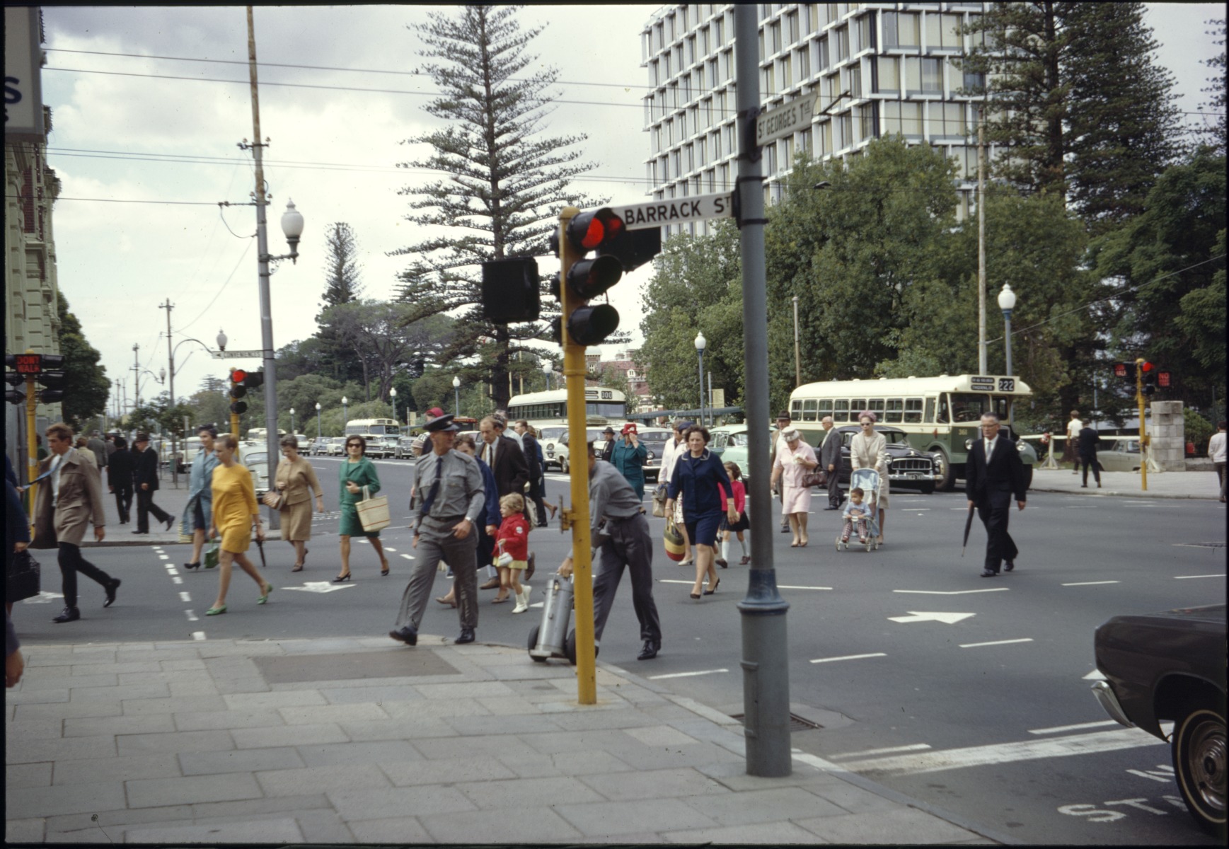 Pedestrians cross the intersection of Barrack Street and St Georges ...