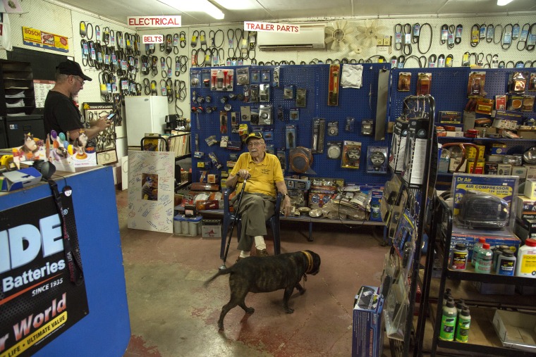 100 year old Jack Renault with his dog Boyo at his auto parts business