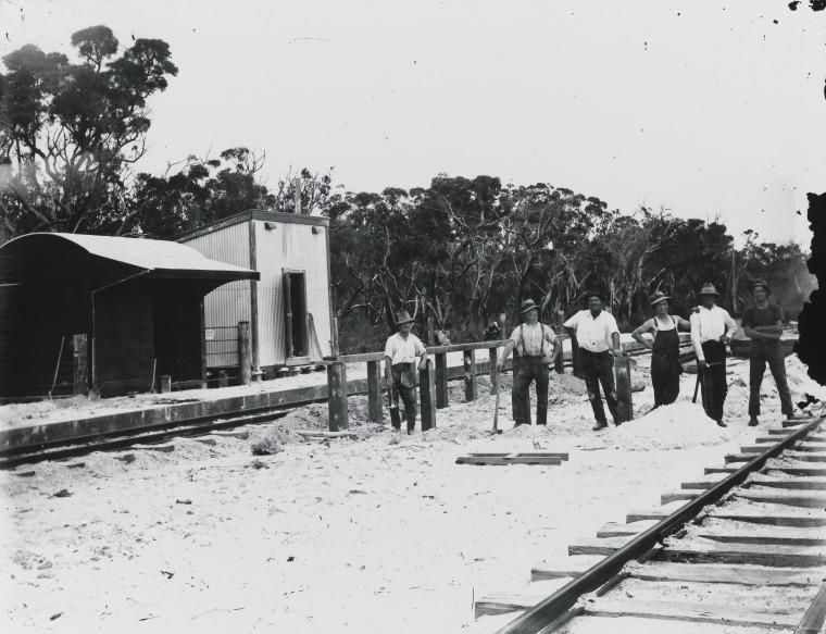 Railway construction workers building a station stop during the ...