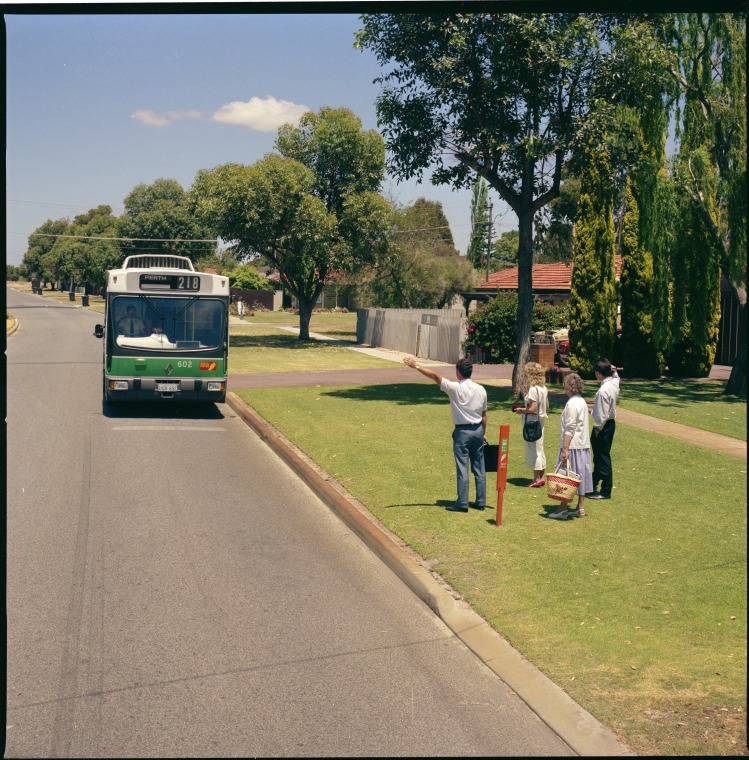 Commuters flag down a bus on a Perth suburban street, 21 October 1988