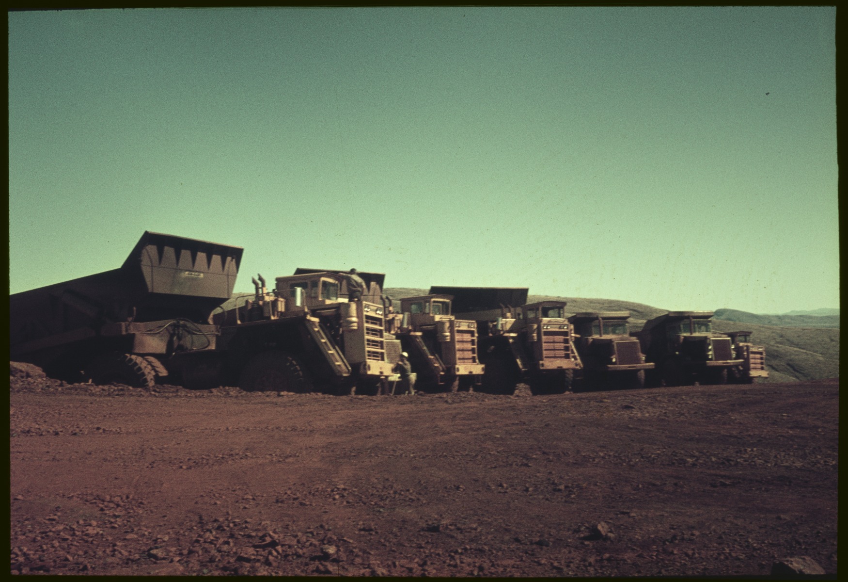 Dump trucks, Mount Tom Price Mine, Western Australia. State Library